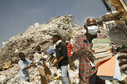 Workers painstakingly retrieve records from the ruins of the tax office; image courtesy of ICBS