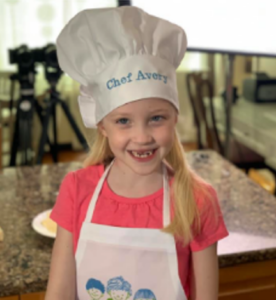 Chef Avery, who was involved in the cooking with Avery programme. Image: child in an apron and chef's hat