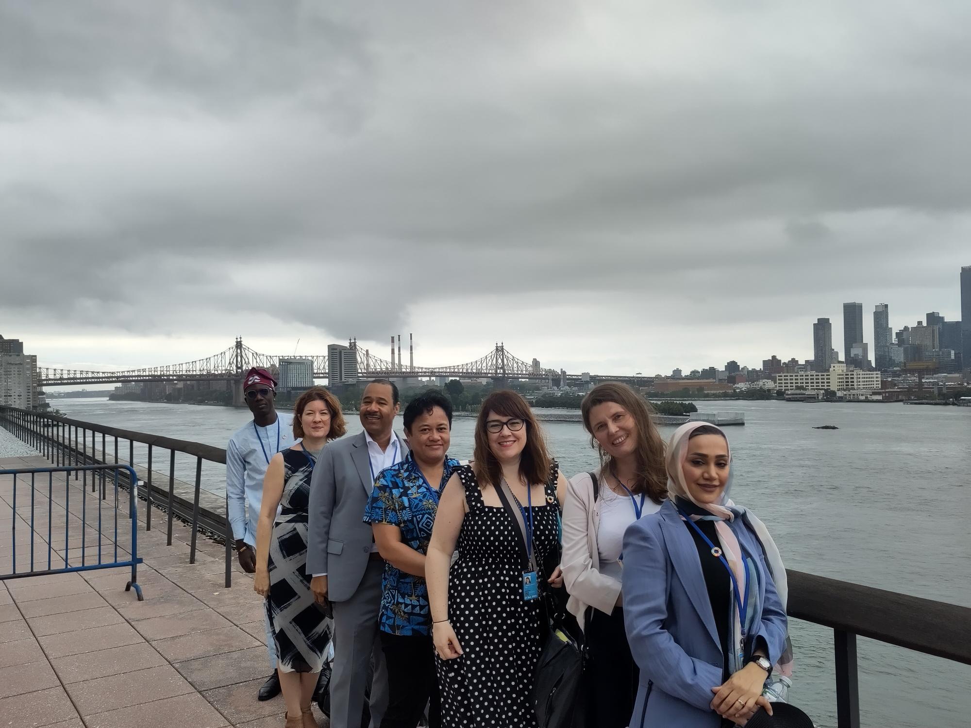 Group of IFLA representatives next to the East River in New York, with a cityscape further on