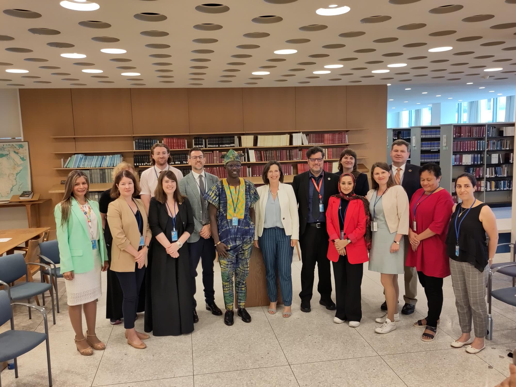 Group of people posing for a photo in a library