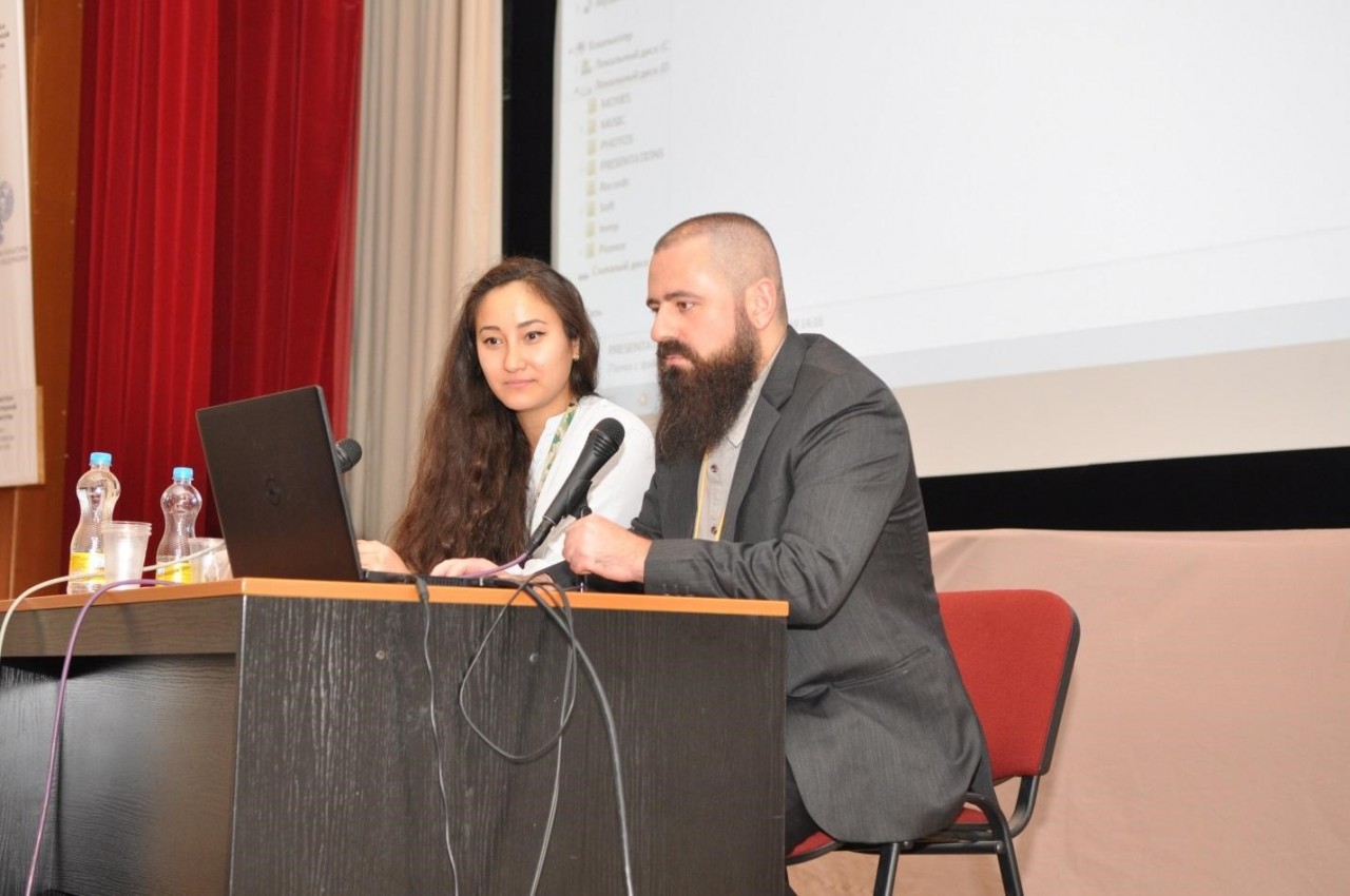 Conservation specialists Mariia Kolpakova (L) and Fareed AlShishani (R) participate at the Interdisciplinary Scientific and Practical Conference â€œRare Books in the Context of Preservationâ€  in Moscow.